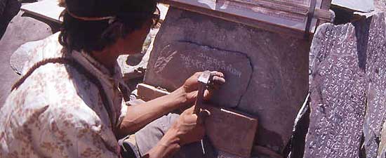 Written in stone: author chisels mantras onto stone